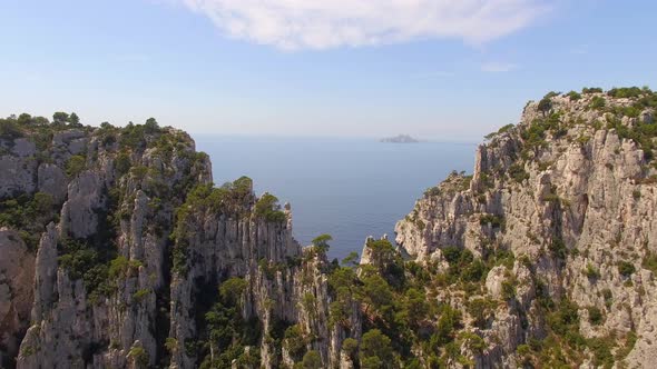 Aerial travel drone view of clear green water, cliffs of Cassis, Mediterranean Sea, Southern France.