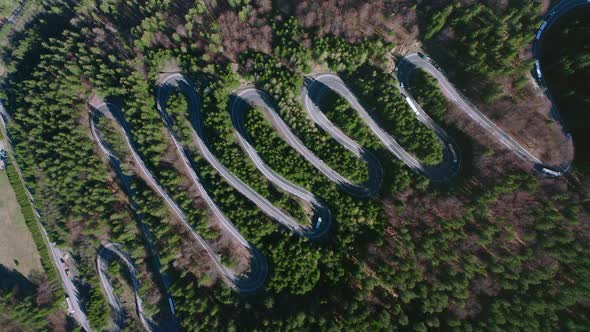 Aerial View Of The Vehicles Swerving At The Bratocea Pass Amidst The Lush Forest In Romania