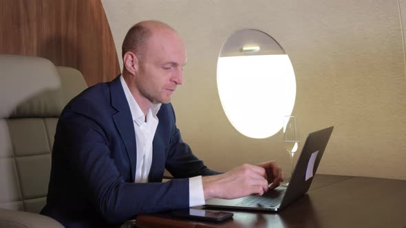 Close Up of a Young Businessman Working Using a Computer Laptop Doing Business flying