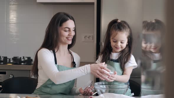 Beautiful Mother and Daughter Are Cooking Together