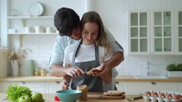 Closeup Happy Couple Cooking Together at Home. Beautiful Man and Woman Having Fun. A Young Couple