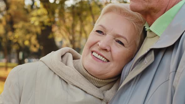 Happy Middle Aged Pretty Caucasian Elderly Woman Grandma Smiling Stand Relax in Autumn Park Spend