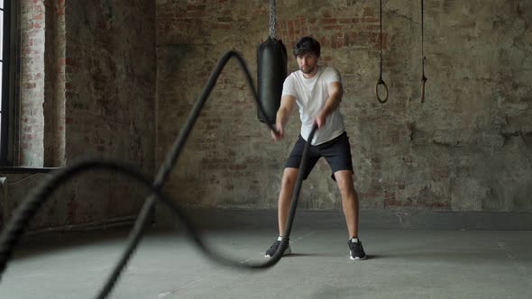 Powerful Man Training with Rope in Functional Training Fitness Gym