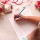 A little girl writes and draws a letter to Santa Claus - VideoHive Item for Sale