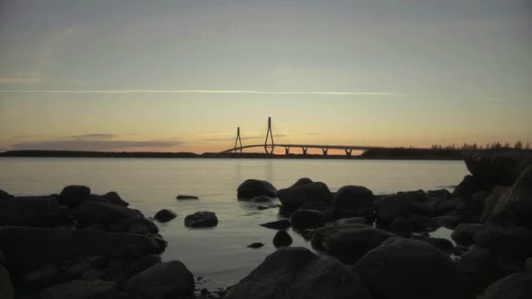 motion timelapse of cable-stayed turfform bridge at sunset turning into night