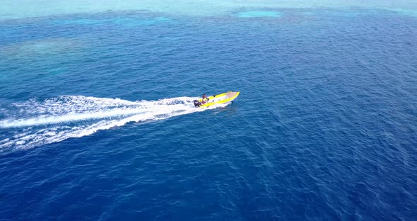 Wide overhead clean view of a white sandy paradise beach and aqua turquoise water background in hi r