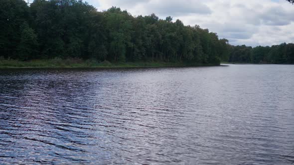 A Calm Summer Evening on the Bank of a Forest River