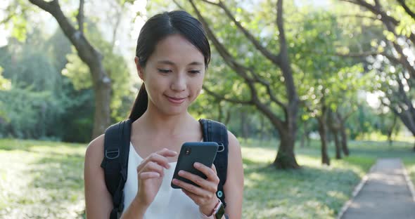 Woman use of mobile phone in the countryside