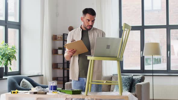 Man with Laptop Preparing Old Chair for Renovation