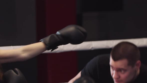 Young Man and Woman Training Boxing Dodging on the Ring