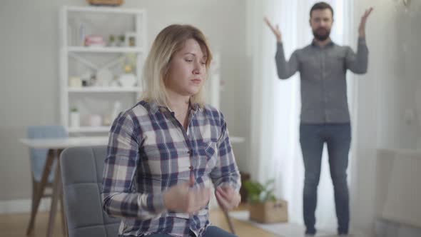 Portrait of Stressed Angry Caucasian Woman Taking Off Wedding Ring and Stretching Hand