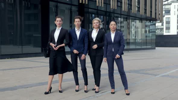 Four Business Women Smilingl Ooking at Camera