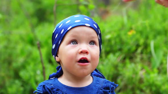 Emotional portrait of little girl on forest background