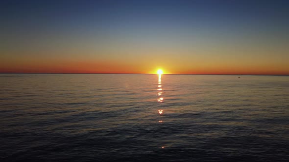 Flying Over the Sea in Sunrise