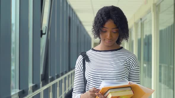 African American Woman Student with a Books in the University. New Modern Fully Functional Education