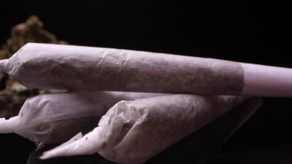 Up close panning view of marijuana rolled in joint