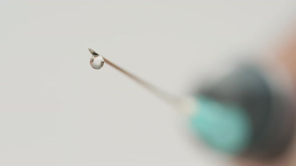 Droplets falling from a syringe needle