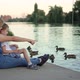 Mother and Child in Medical Masks Feed Ducks on the Lake - VideoHive Item for Sale