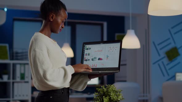 Focused Black Manager Woman Checking Business Report Holding Laptop