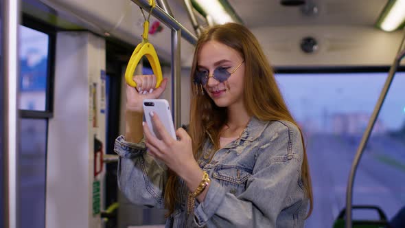 Woman Playing on Smartphone Chatting Texting Browsing Social Media While Traveling By Bus to City