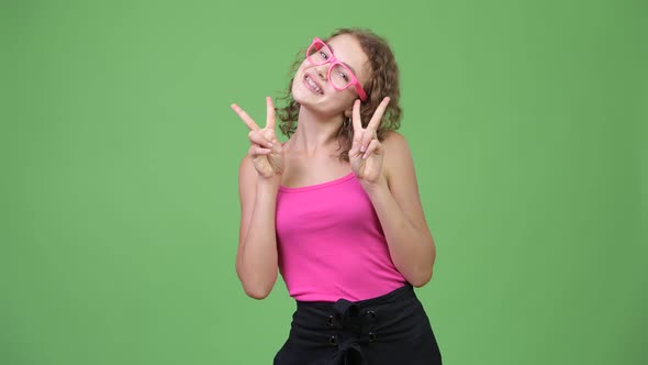 Young Happy Beautiful Nerd Woman Smiling While Giving Peace Sign
