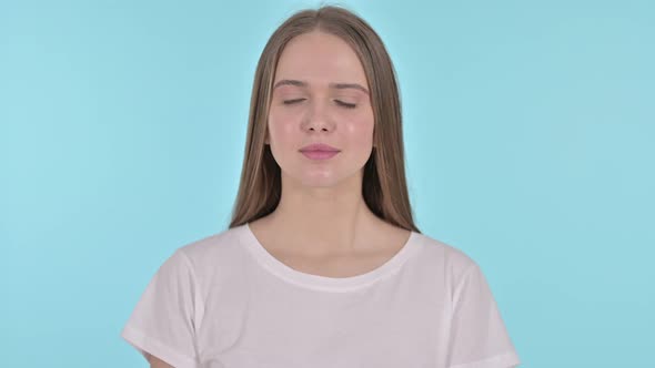 Thumbs Down By Young Woman, Blue Background