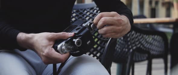 Man taking camera film out of his camera