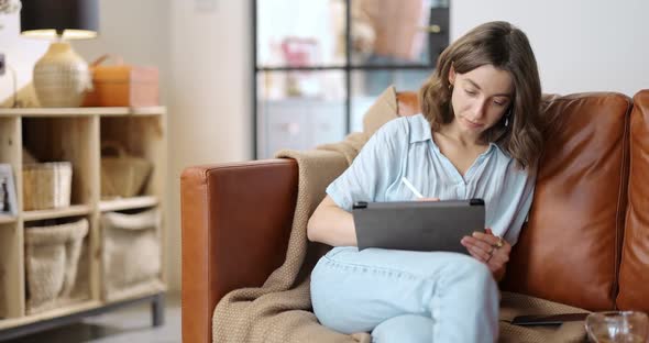 Female Artist Working on a Digital Tablet at Home