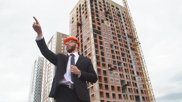 Engineer Using Gestures Gives Instructions at the Construction Site. Slow Motion