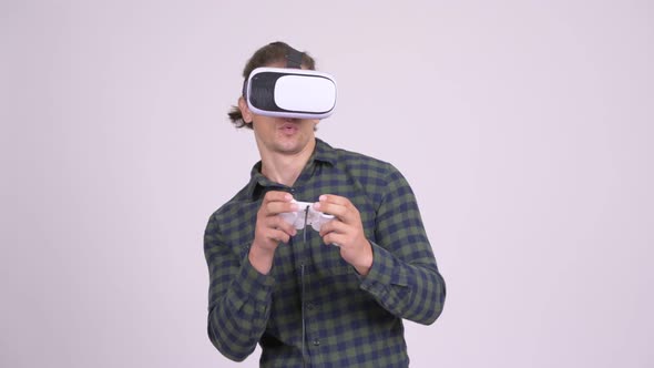 Handsome Hipster Man Playing Games with Virtual Reality Headset