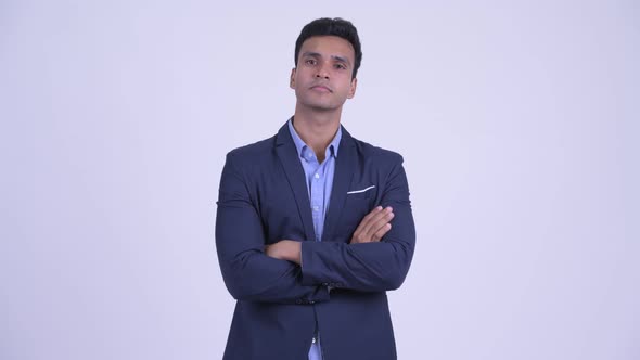Young Happy Indian Businessman in Suit Smiling with Arms Crossed