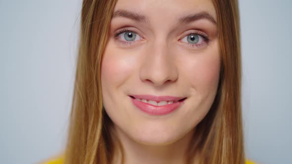 Closeup Beautiful Woman Shaking Yes with Head at Camera on Grey Background