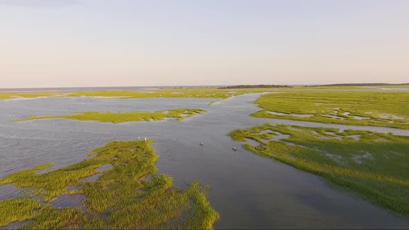 Kayakers in a creek at sunset in Murrells Inlet SC