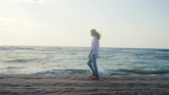 Girl Walking Along Sea Shore