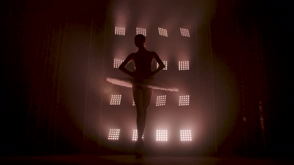 Graceful Silhouette Ballerina Dancing in Black Dress in the Studio in Spotlight on the Stage of the