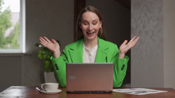 Cheerful Woman Gets Happy Looking at Screen of Laptop