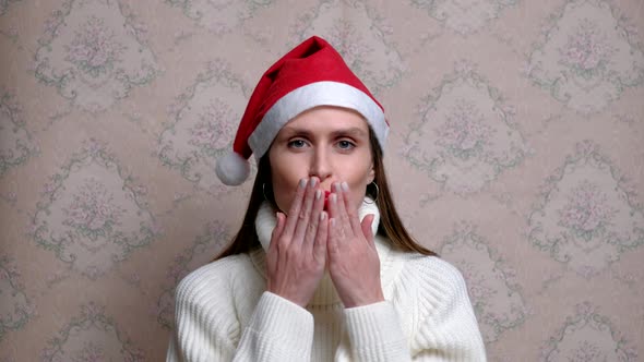 Young Positive Dancing Woman with Christmas Cap and Headphones.