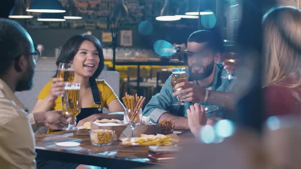 Group of young multiracial friends clinking glasses in bar / Videohive
