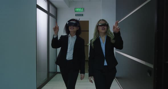 Businesswomen Using VR Glasses in Office Corridor