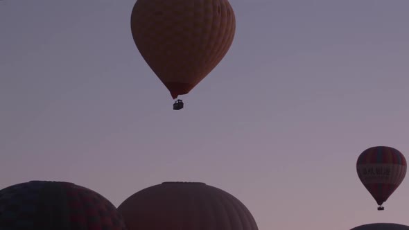 Hot air balloons take off from the fields around Goreme, Cappadocia, at sunrise