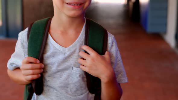 Portrait of cute schoolboy standing with backpack 4k