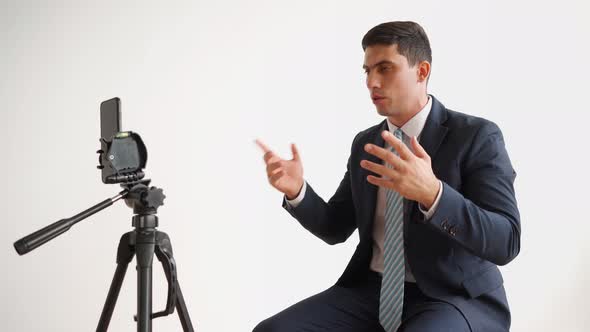 Business Man in Formal Clothes Jacket and Tie Broadcasting Live Using Phone