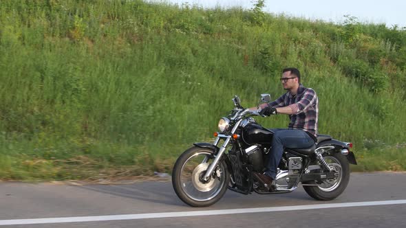 Brutal Man Riding a Motorcycle. Overhead Shot