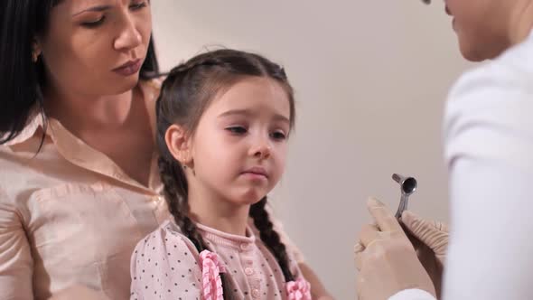 Crying Child Patient During Examination of Nose