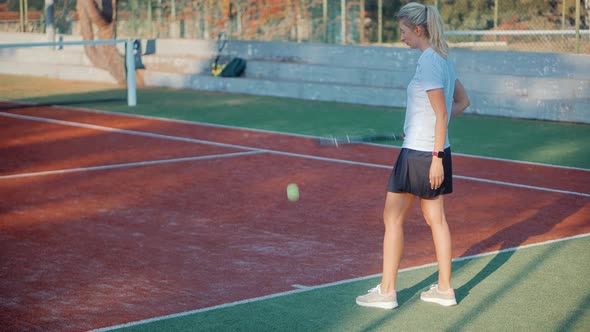 Female Tennis Player Preparing To Set Ready To Serve Ball. Girl With Rocket Playing On Tennis Court.