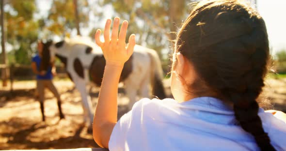 Girl waving hand to her mother in ranch 4k