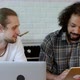 Two Young Male Freelancers Are Working At Home on an Online Project, Using a Laptop - VideoHive Item for Sale