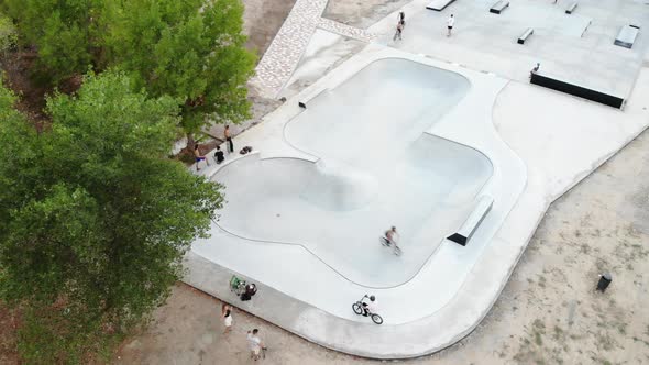 Skate park with men riding bicycles