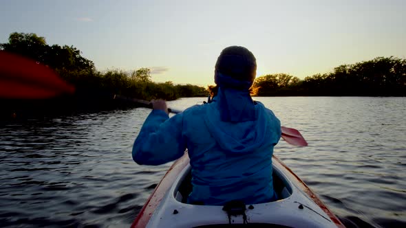 A Woman Is Kayaking