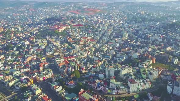 Drone Camera Shows Beautiful City Located on Green Hills